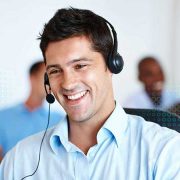 a guy giving technical support on call with a smile